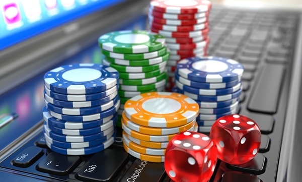 Virtual casino. Online gambling. Laptop with dice and chips.