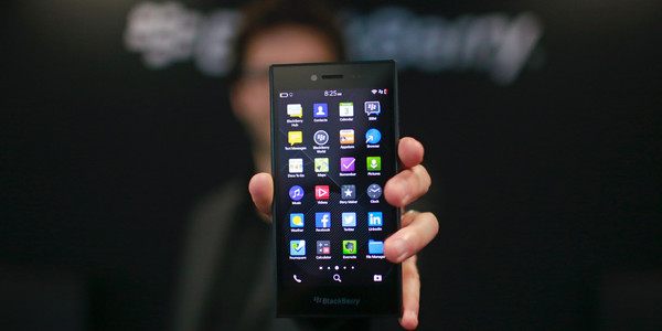 An employee holds a new BlackBerry Ltd. Leap smartphone for an arranged photograph at the Mobile World Congress in Barcelona, Spain, on Tuesday, March 3, 2015. The event, which generates several hundred million euros in revenue for the city of Barcelona each year, also means the world for a week turns its attention back to Europe for the latest in technology, despite a lagging ecosystem. Photographer: Pau Barrena/Bloomberg via Getty Images