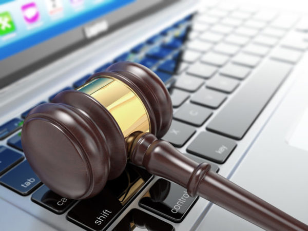 Online auction. Gavel on laptop. Conceptual image. 3d